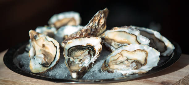 Oysters on the black plate in the restaurant