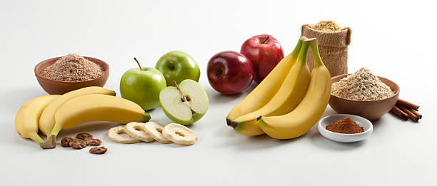 Apples, bananas and cinnamon composition, on white background.