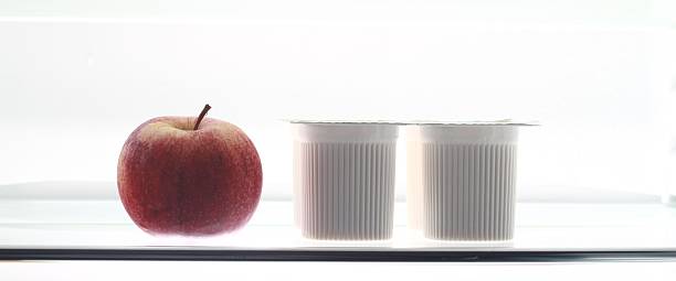 red apple and yogurt in refrigerator
