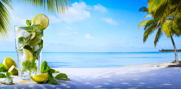 tropic summer vacation; Exotic drinks on blur tropical beach background
