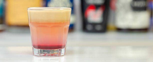 A colorful layered drink shot on a bar prepared by Bartender, party time