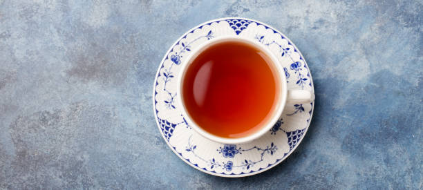 Cup of tea on a blue stone background. Copy space. Top view.