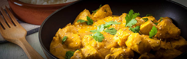 Butter chicken curry with basmati rice and cilantro.